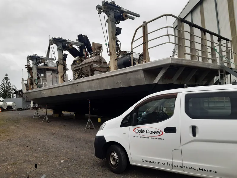 Cole Power van parked outside a marine vessel, showcasing our commitment to marine and industrial electrical services.